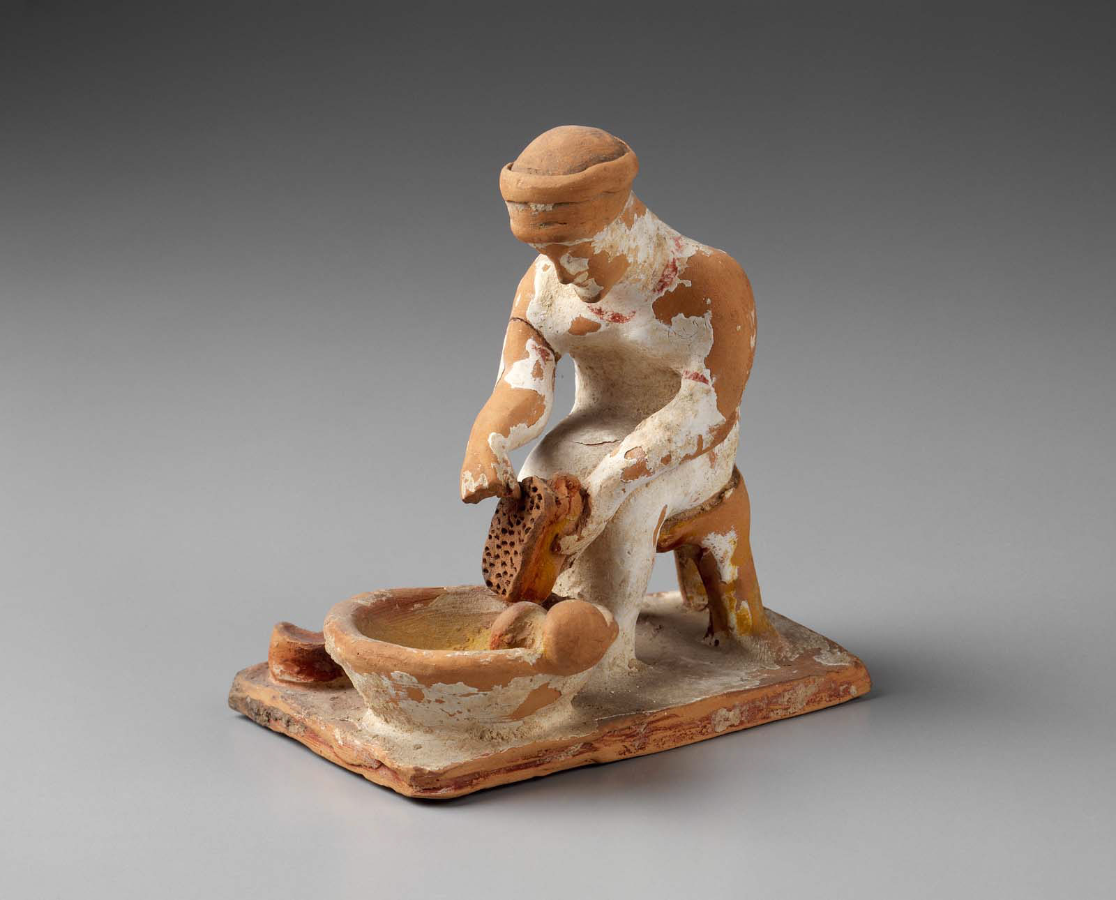  Woman grating cheese - Greek -Late Archaic Period -Early 5th century B.C.